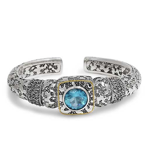 Gold & Silver bracelet kick cuff with Balinese Jawan setting with plaster motif. Set with Blue topaz Sky