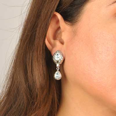 Gold & Silver earring with puzzle motif. Set with Blue topaz sky Pearshape